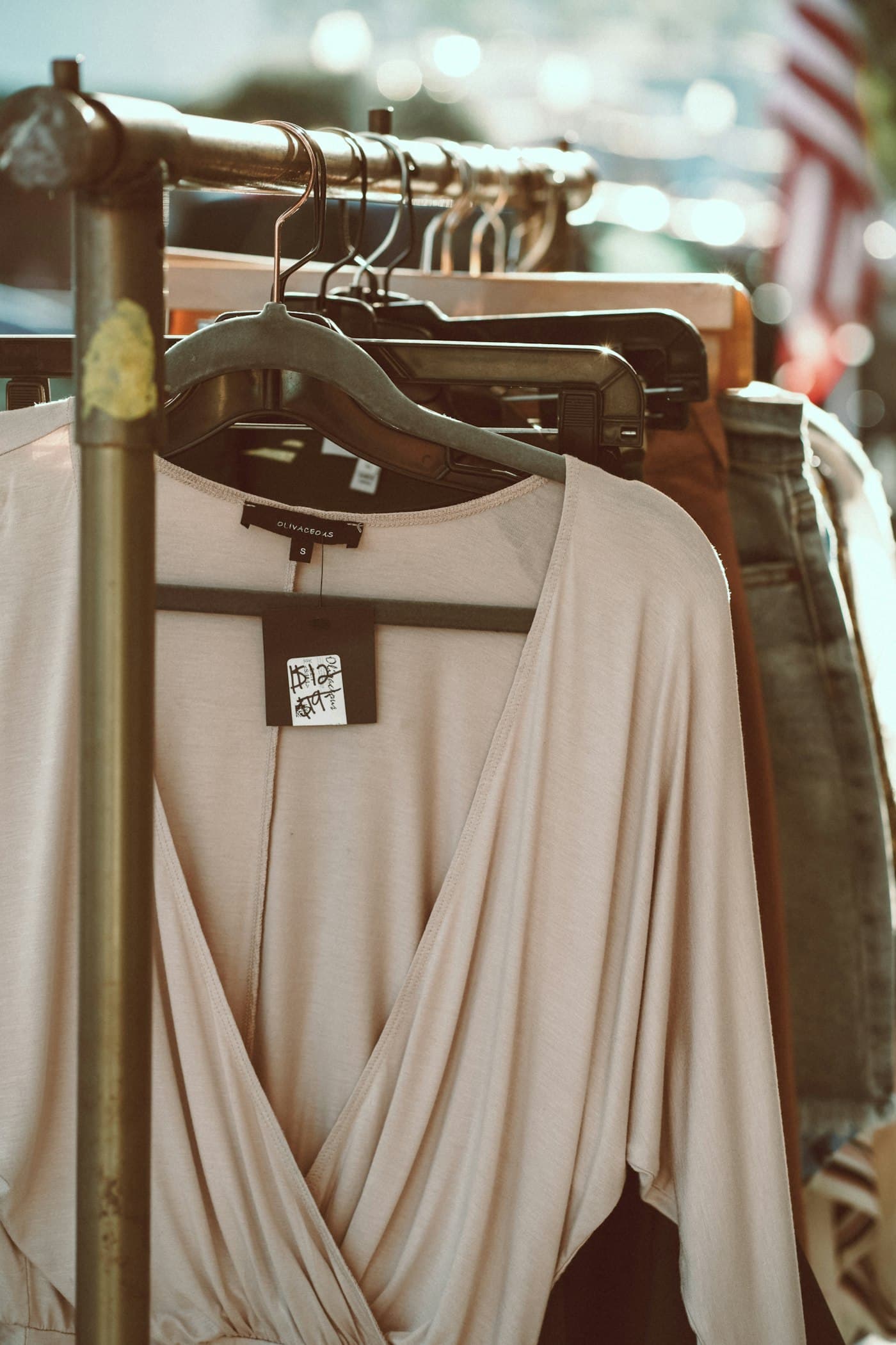 Cream wrap blouse on a wooden hanger