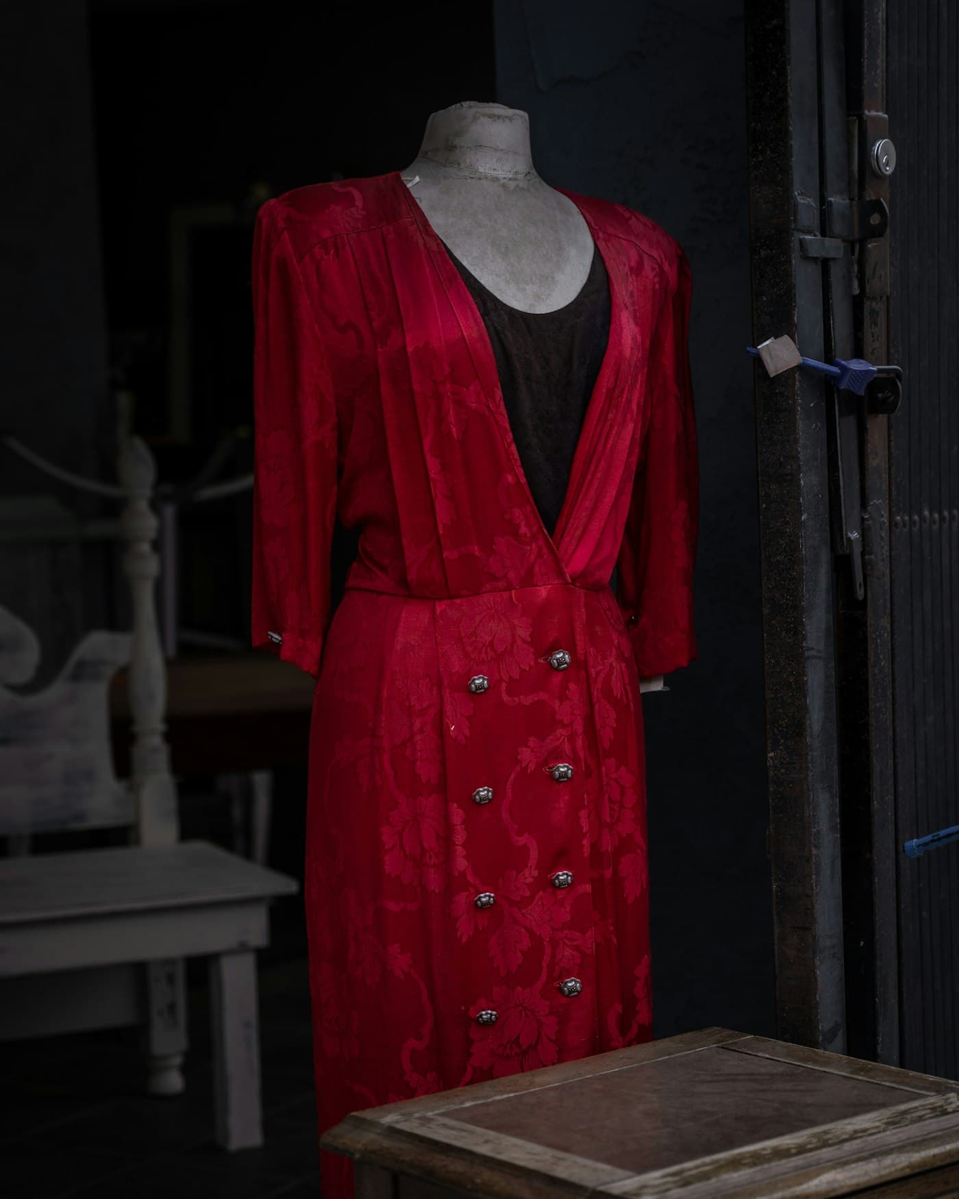 Red buttoned vintage dress on a mannequin